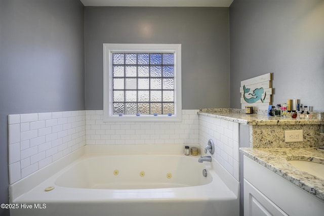 bathroom featuring a jetted tub and vanity