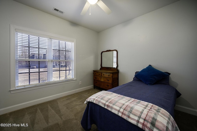 carpeted bedroom with a ceiling fan, visible vents, and baseboards