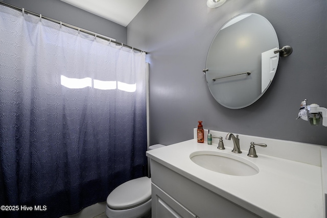 bathroom with a shower with shower curtain, vanity, and toilet