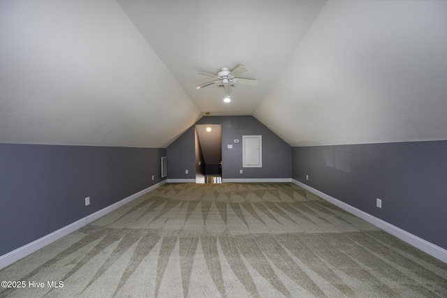 additional living space with visible vents, baseboards, a ceiling fan, carpet, and vaulted ceiling