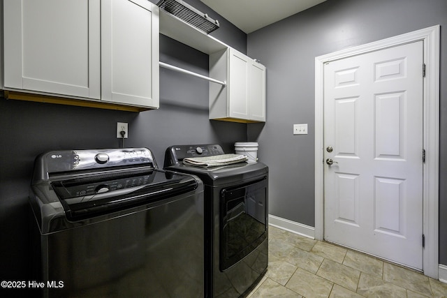 laundry area with baseboards, cabinet space, and washer and dryer