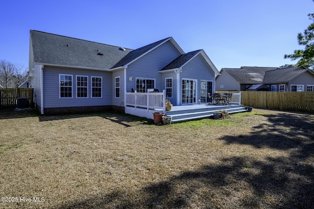 rear view of house featuring central AC, a lawn, fence, and a wooden deck