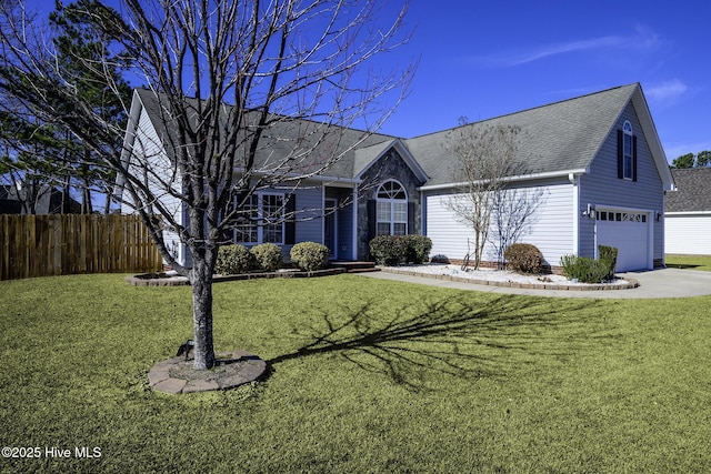 view of front of house with a garage, fence, driveway, and a front lawn