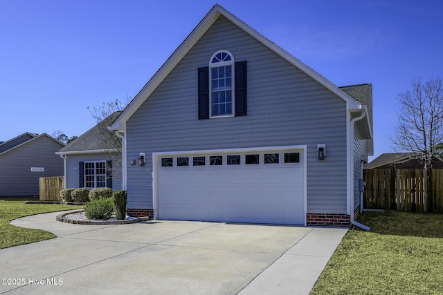 traditional-style home with driveway, an attached garage, fence, and a front lawn