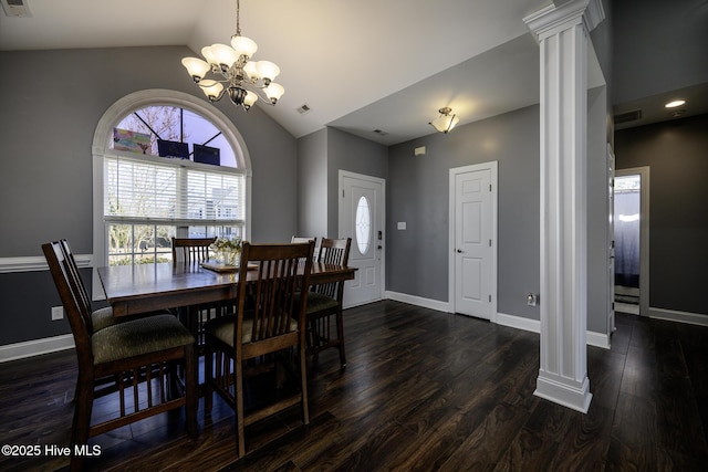 dining space with decorative columns, vaulted ceiling, visible vents, and dark wood finished floors