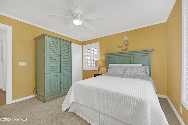 bedroom with ornamental molding, light colored carpet, ceiling fan, and baseboards