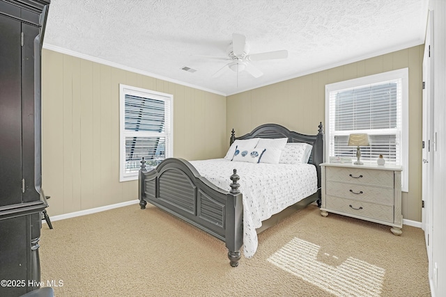 bedroom featuring visible vents, ornamental molding, light carpet, ceiling fan, and a textured ceiling