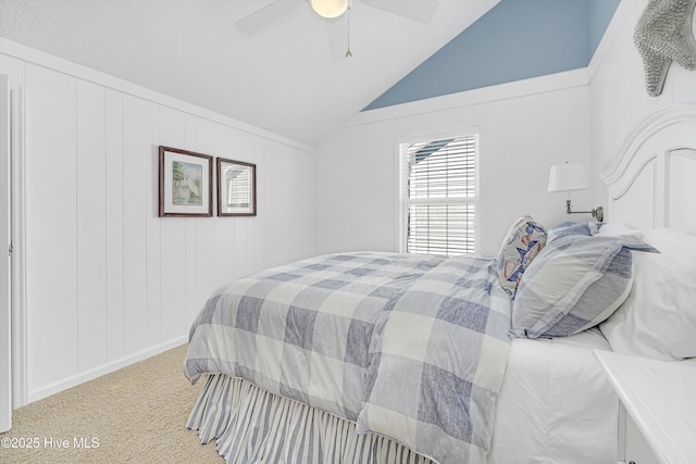 carpeted bedroom with vaulted ceiling and a ceiling fan