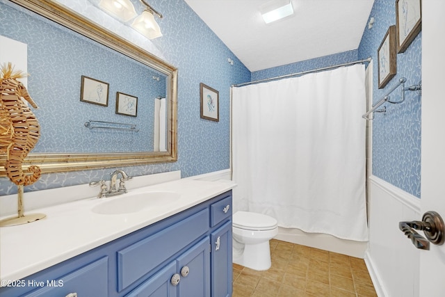 bathroom with tile patterned flooring, toilet, vanity, shower / bath combo, and wallpapered walls