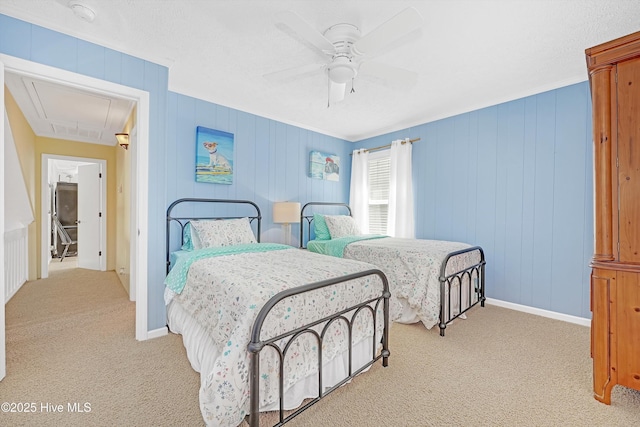 bedroom with attic access, baseboards, a ceiling fan, and light colored carpet