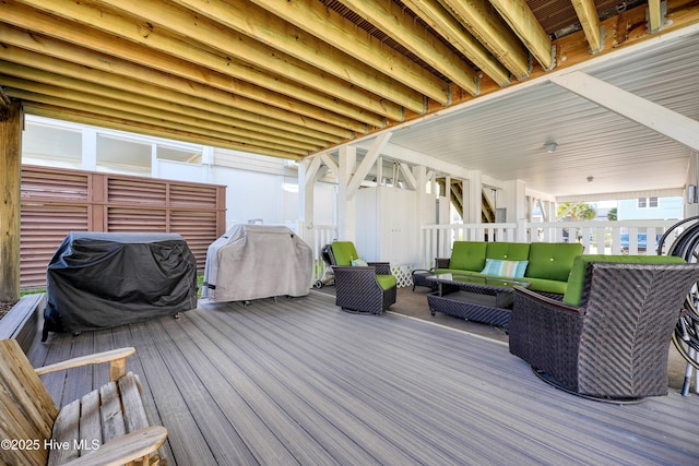 deck with a grill and an outdoor hangout area