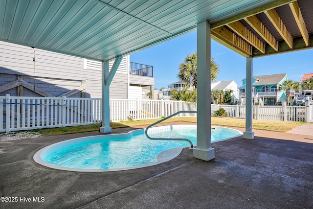 view of swimming pool featuring a patio area, a fenced backyard, a residential view, and a fenced in pool