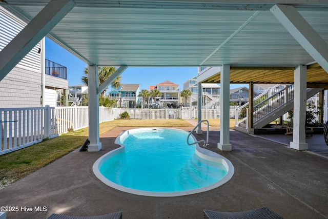 view of swimming pool with a fenced in pool, a residential view, a fenced backyard, and a patio