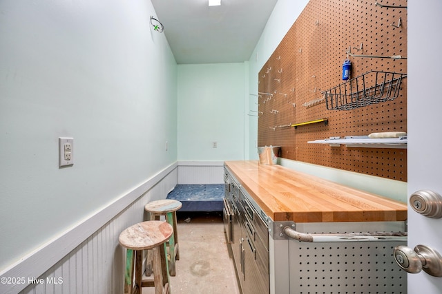 interior space with concrete floors and wainscoting