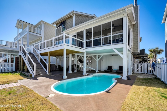 rear view of house featuring a fenced in pool, a patio, a ceiling fan, fence, and stairs