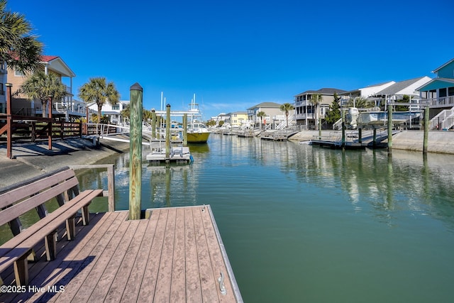 dock area with a residential view and a water view