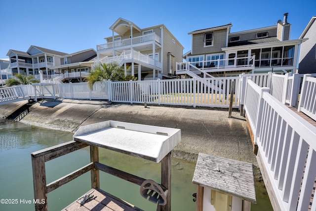 dock area with a water view and fence