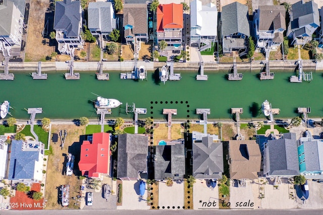 birds eye view of property with a water view and a residential view