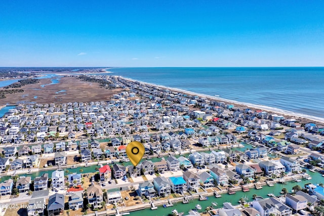 birds eye view of property featuring a water view, a residential view, and a view of the beach