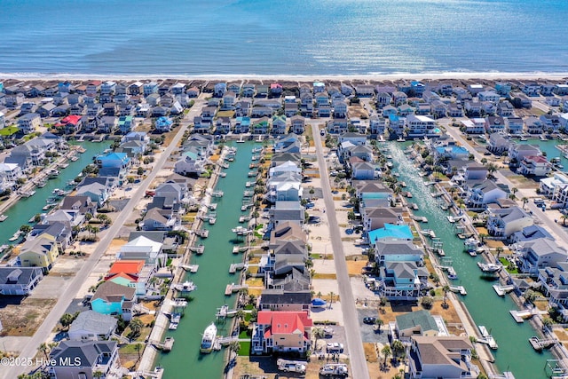 drone / aerial view with a residential view and a water view