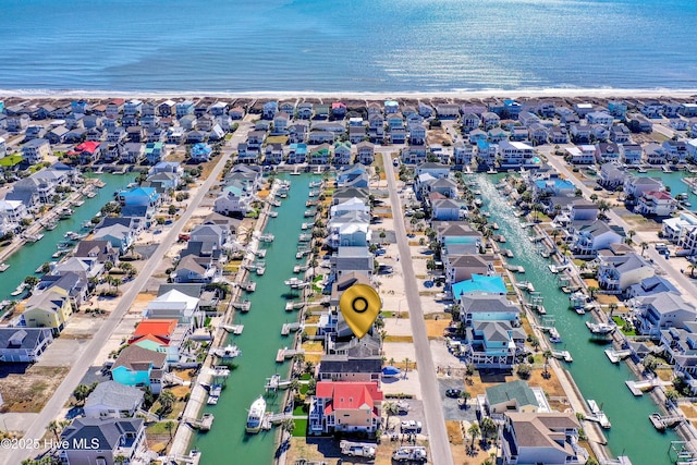 drone / aerial view featuring a residential view and a water view