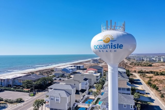 aerial view with a water view and a beach view