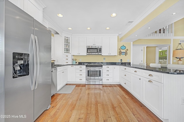 kitchen with stainless steel appliances, glass insert cabinets, and white cabinetry