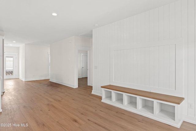 interior space featuring recessed lighting, baseboards, and light wood finished floors