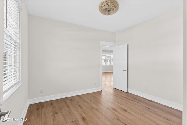 unfurnished room featuring light wood-style flooring and baseboards