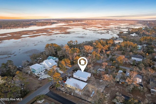 aerial view at dusk with a water view