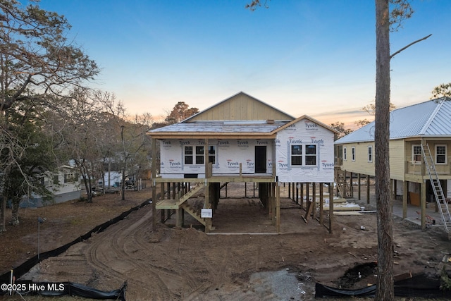 view of front of house featuring a carport and stairway