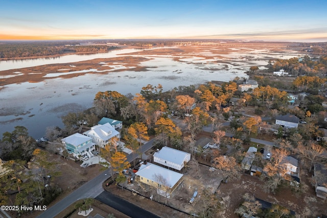 aerial view at dusk with a water view