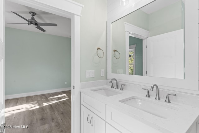6803 E Yacht Dr, Oak Island, NC 28465 - bathroom featuring wood finished floors, double vanity, and a ceiling fan
