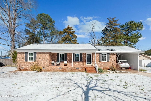 ranch-style house featuring driveway, crawl space, fence, a carport, and brick siding