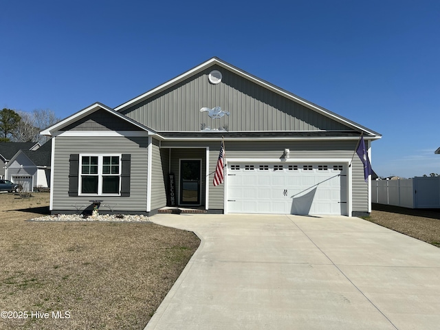 ranch-style home featuring driveway, a garage, and fence