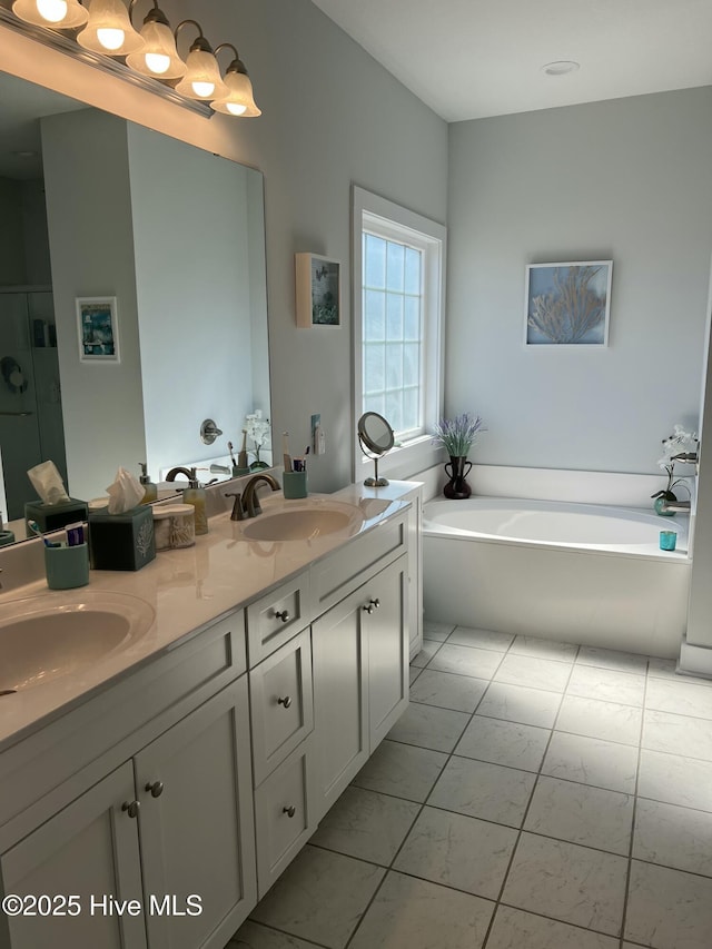 bathroom with double vanity, a bath, a stall shower, and a sink