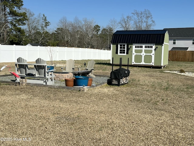 view of yard featuring an outbuilding, a storage shed, and a fenced backyard