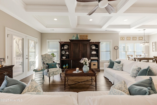 living room featuring ornamental molding, beam ceiling, a healthy amount of sunlight, and dark wood finished floors