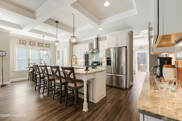 kitchen with tasteful backsplash, dark wood-style flooring, stainless steel appliances, wall chimney range hood, and beam ceiling