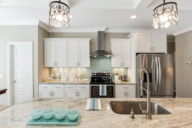 kitchen with white cabinets, wall chimney exhaust hood, an inviting chandelier, stainless steel appliances, and crown molding