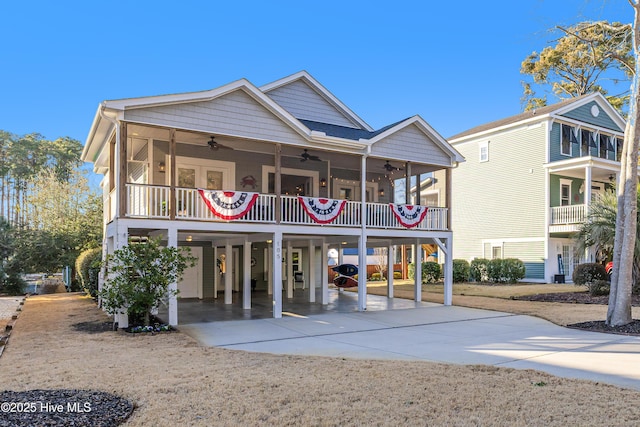 exterior space featuring a carport, driveway, and a ceiling fan