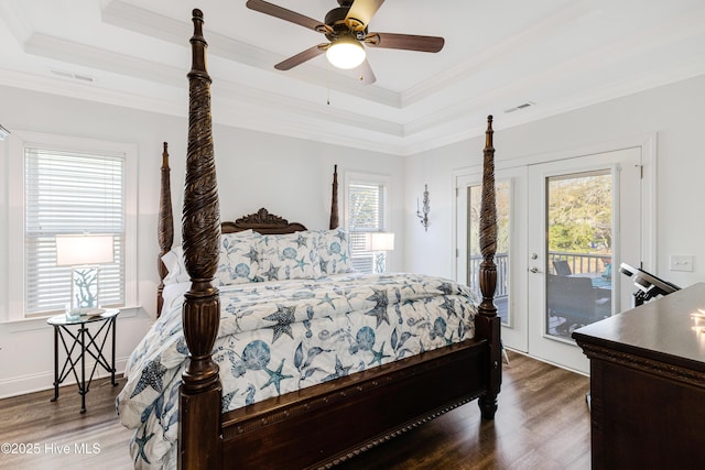 bedroom featuring access to exterior, a raised ceiling, visible vents, ornamental molding, and wood finished floors