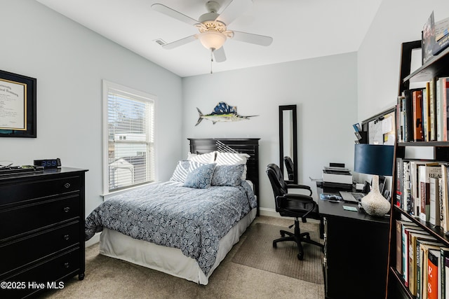 carpeted bedroom featuring visible vents and a ceiling fan