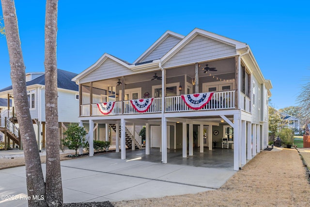 exterior space featuring driveway, a ceiling fan, and a carport