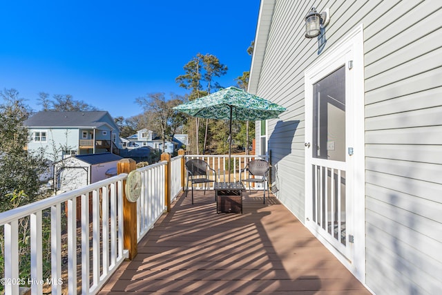 wooden terrace with a residential view