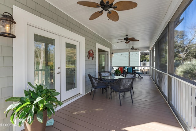 sunroom / solarium featuring french doors