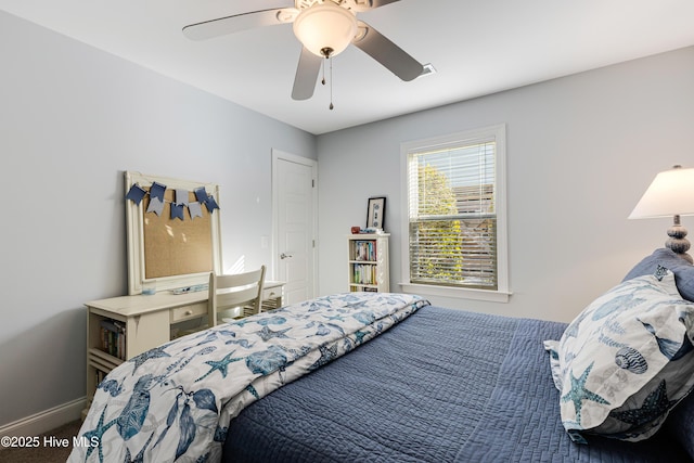 bedroom with ceiling fan, carpet floors, and baseboards