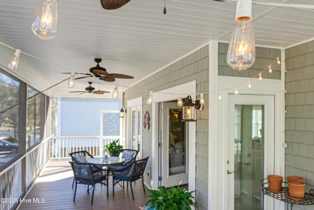 sunroom with a ceiling fan