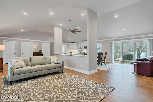 living room with recessed lighting, high vaulted ceiling, baseboards, and wood finished floors