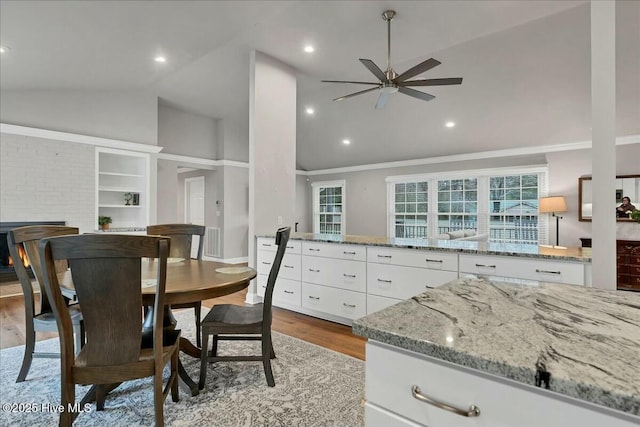 dining area with ceiling fan, high vaulted ceiling, wood finished floors, and recessed lighting